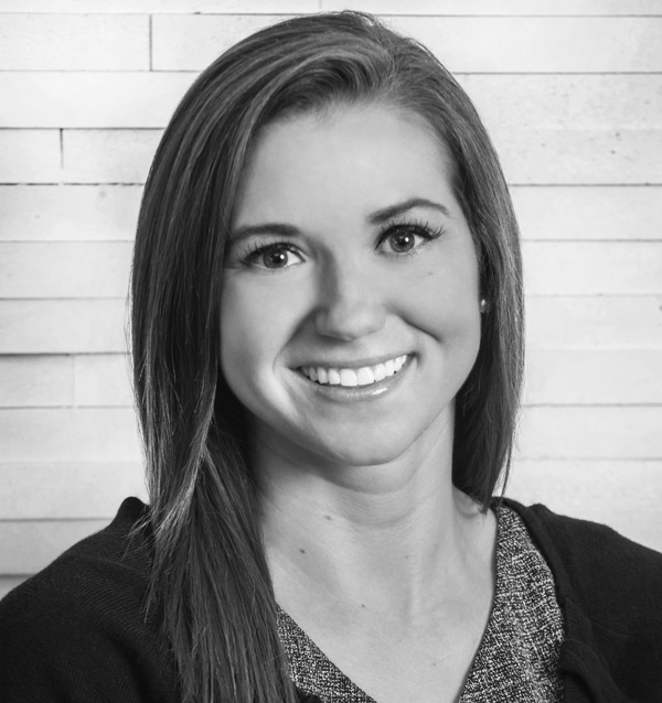 Black and white headshot of smiling woman